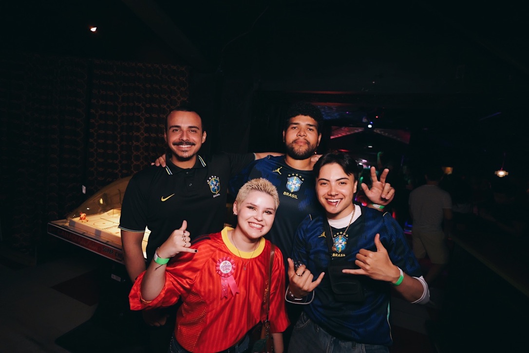 Friends wearing Brazil jerseys together at a BrazilFeel event